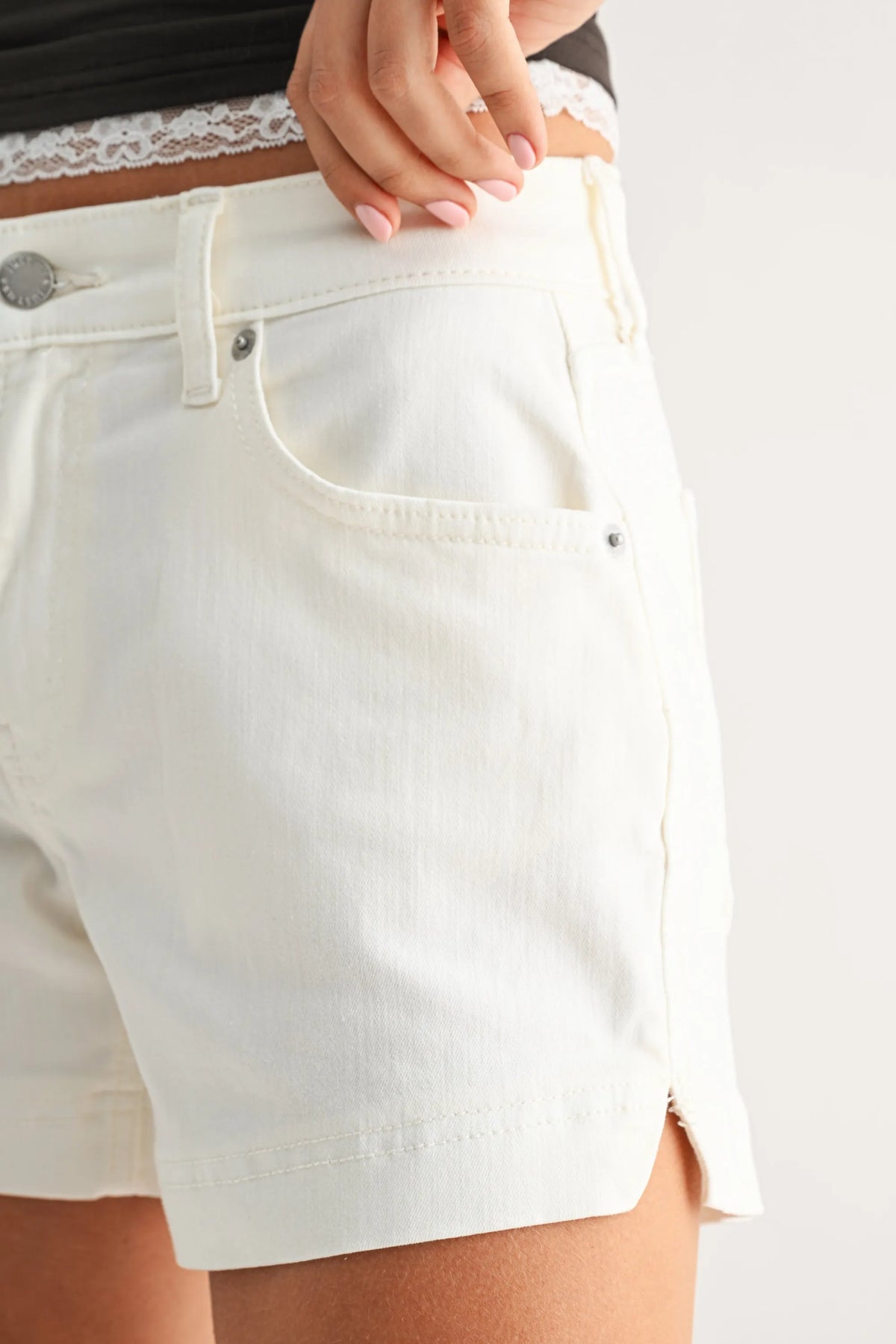 White low rise slit lightweight short denim shorts with subtle texture silver hardware and tailored fit