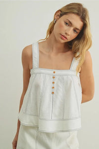 White denim stitch detailed sleeveless top with thin straps and subtle vertical stitching for casual wear