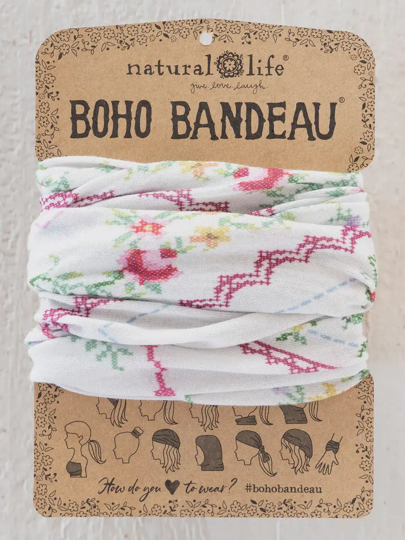 White embroidered boho bandeau headband with pink green and yellow floral heirloom cross stitch on ivory fabric