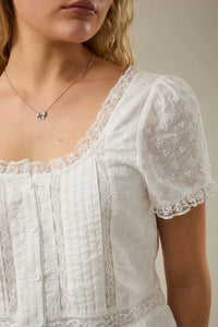 White embroidered lace trim blouse with cap sleeve scoop neck and puff sleeves for elegant occasions