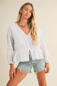 White V ruffle neck blouse with embroidered peasant style, ruffled sleeves and hem