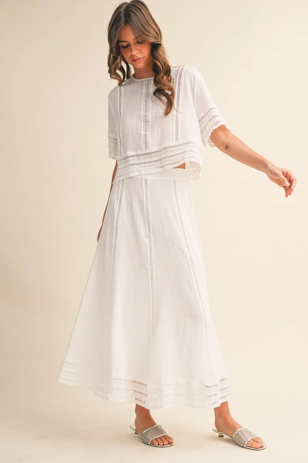 White embroidered two-piece outfit featuring a lace trim cotton maxi skirt with delicate lace detailing and flowing skirt