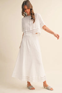 White embroidered two-piece outfit featuring a lace trim cotton maxi skirt with delicate lace detailing and flowing skirt