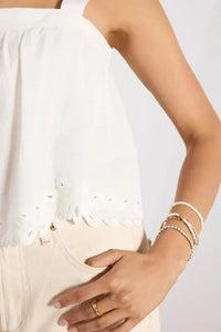 White eyelet square neck adjustable straps tank with built-in bra and delicate scalloped hem in soft flowing fabric