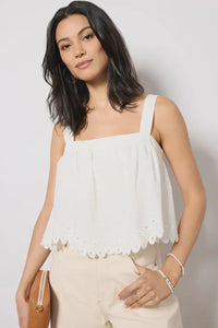 White eyelet fabric top with square neck adjustable straps and built-in bra features a flared scalloped hemline
