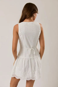 White sleeveless eyelet mini dress with tied waistband and scalloped hem in lightweight lace fabric