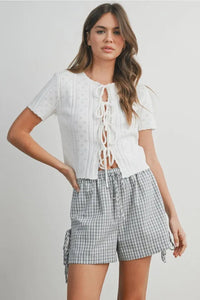 White eyelet pointelle knit crop top with scalloped tie front and short sleeves in women’s boho chic clothing style