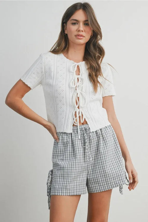 White eyelet pointelle knit crop top with scalloped tie front and short sleeves in women’s boho chic clothing style