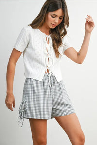 White eyelet pointelle knit cropped top with scalloped tie front and short sleeves in women’s boho chic clothing style