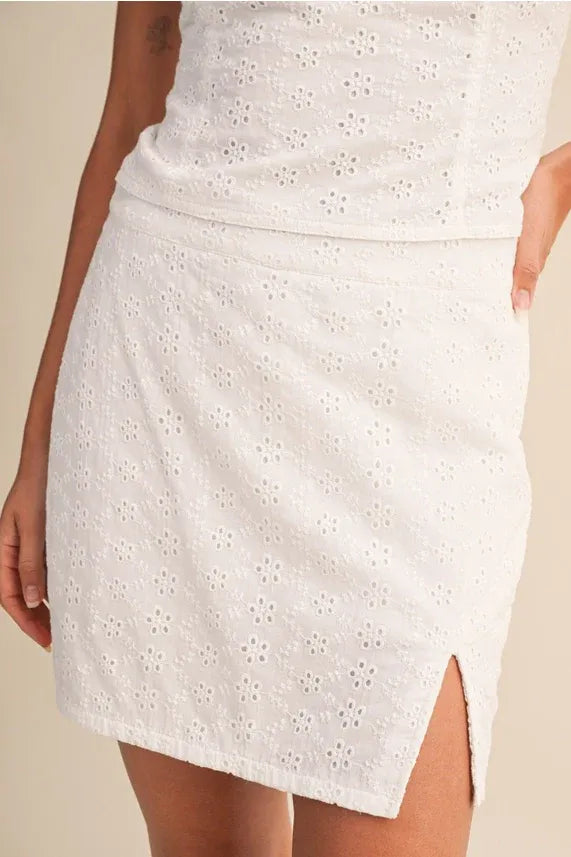 White eyelet slit mini skort with floral pattern and side slit