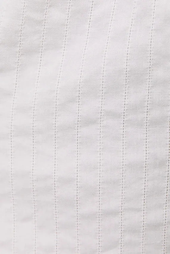 White fabric square neck lace trim detail romper with subtle vertical pinstripes and neck lace trim accents