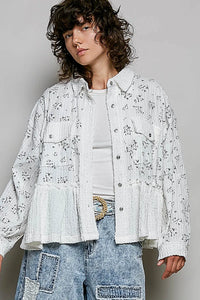 White cotton shirt jacket with floral ruffle detailing button closures and ruffled hem front pockets
