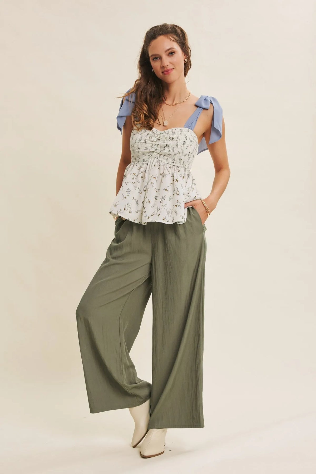 White floral print top with light blue ruffled shoulder straps paired with every step washed look wide leg pants