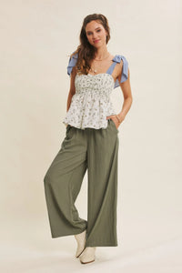 White floral print top with light blue ruffled shoulder straps paired with every step washed look wide leg pants