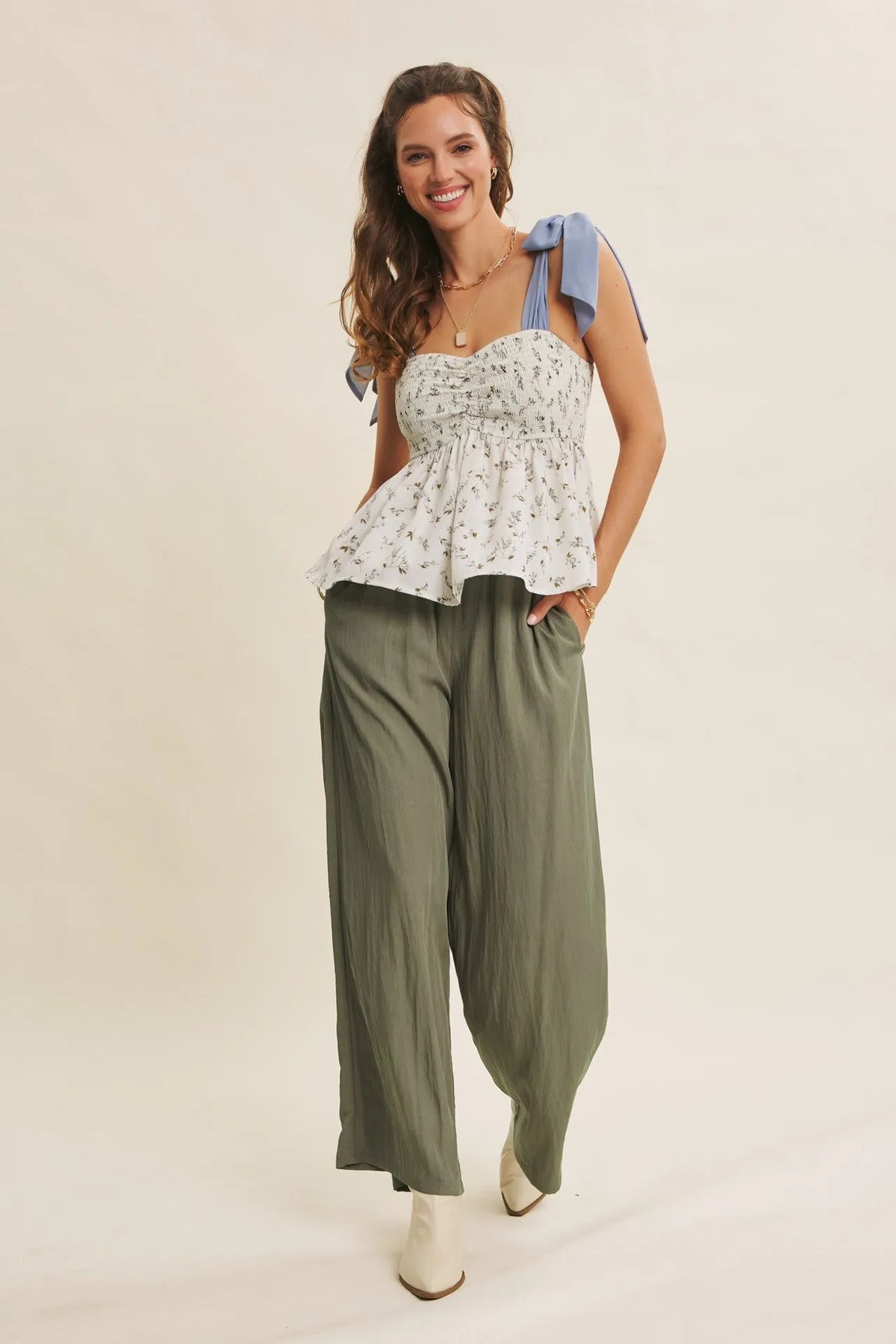 White floral print strap top with light blue bow details paired with step washed wide leg pants
