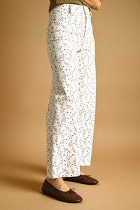 White floral print stretched wide leg pants with soft flowing drape and frayed hem for elegant casual wear