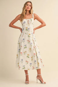 White floral print midi dress with square neckline thin straps showcasing floral tie back lace up detail in womens boho chic clothing