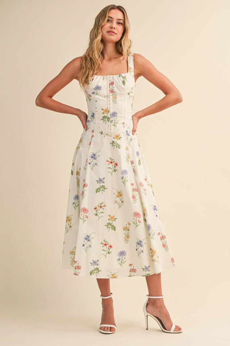 White floral print midi dress with square neckline thin straps showcasing floral tie back lace up detail in womens boho chic clothing