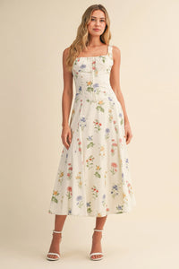 White floral print midi dress with square neckline and thin straps featuring a floral tie back for women’s boho chic clothing