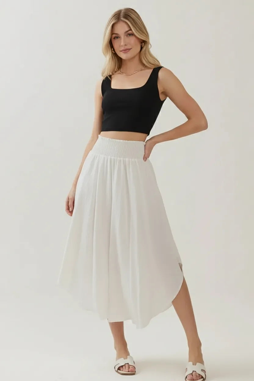 White smocked waistband lined midi skirt with pleated asymmetrical hem