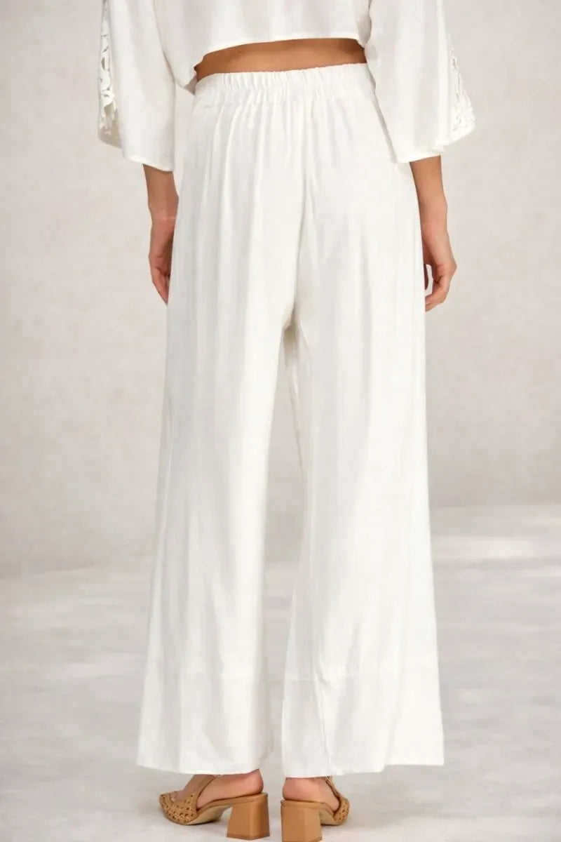 White linen blend wide leg pants with elastic waistband and soft hand feel for relaxed comfortable wear