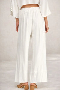 White linen blend wide leg pants with elastic waistband and soft hand feel for relaxed comfortable wear