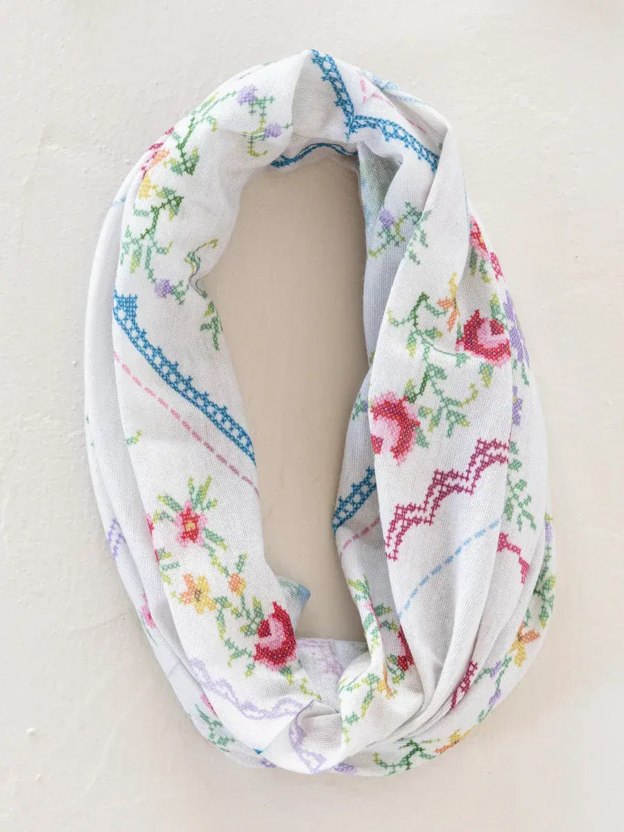 White infinity scarf with colorful embroidered floral patterns in a full boho bandeau heirloom cross stitch ivory design