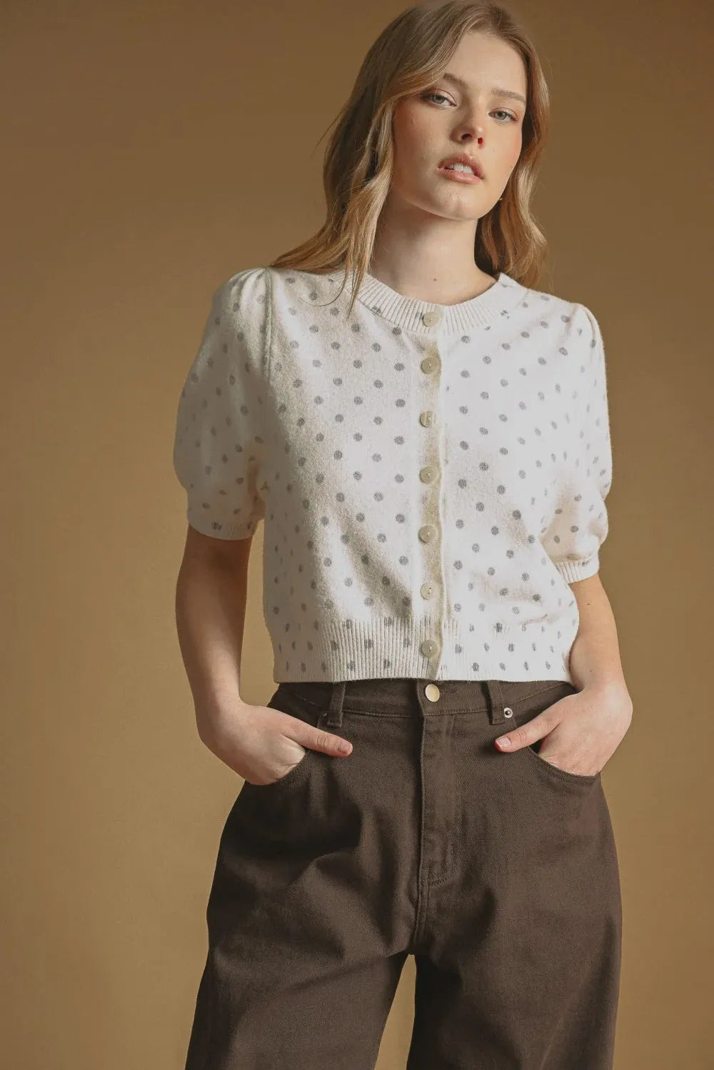 White knit polka dot short sleeve cardigan with puffed sleeves and button front closure