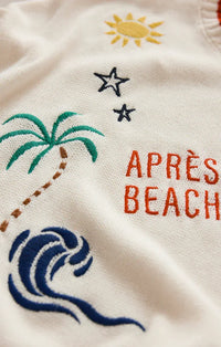White knit sienna sweater with embroidered tropical design and orange après beach text from the day sienna collection