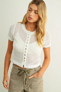 White knitted cropped cardigan with button front and short sleeve knitted design for casual wear