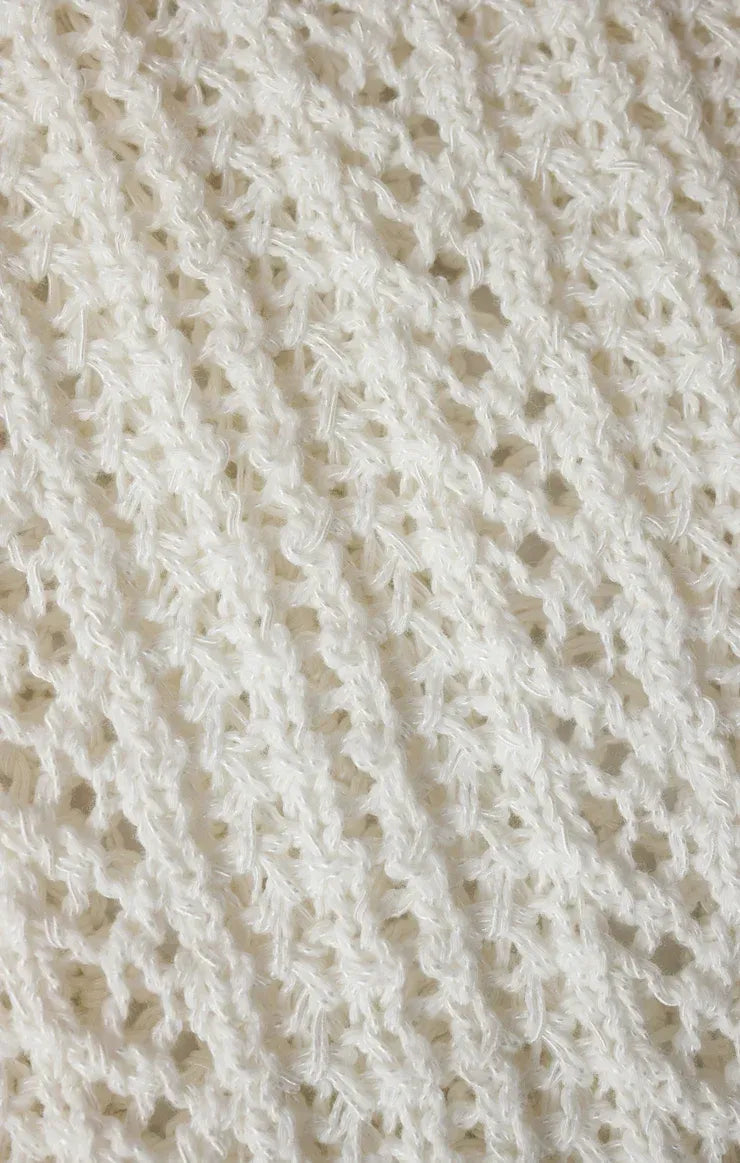 White knitted ballast crochet sweater top featuring a delicate openwork pattern in soft crochet fabric