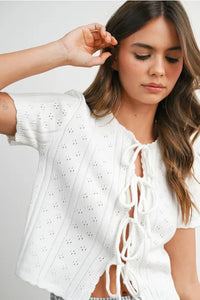 White scalloped tie front pointelle knit top with lace-up front and eyelet detailing in women’s boho chic clothing