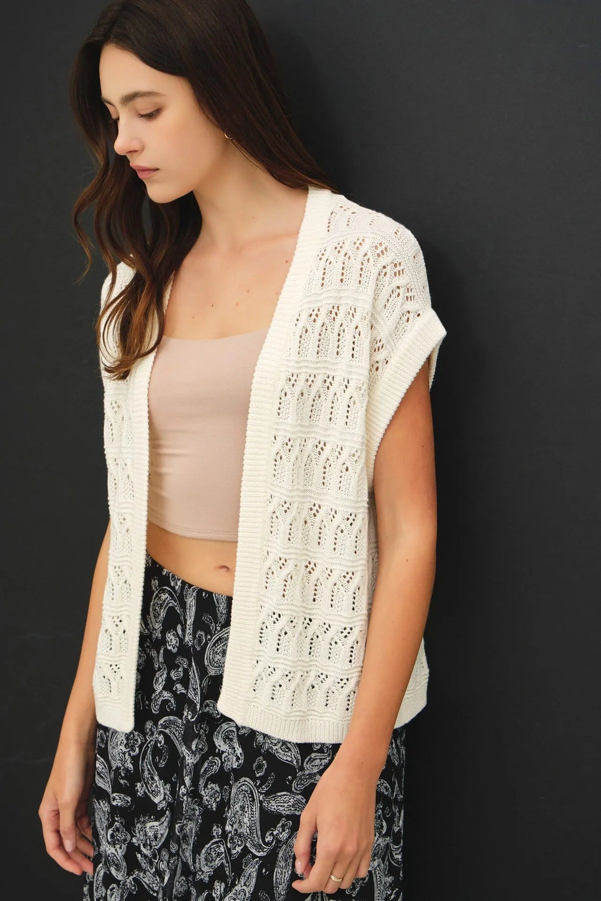 White crochet knit boxy open cardigan with intricate lace patterns and ribbed hem for lightweight layering