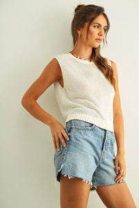 White sleeveless round neck knitted top with ribbed hem and open armholes in a lightweight knit fabric