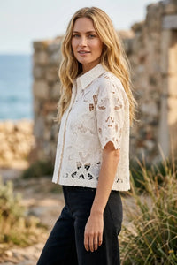 White lace midnight embroidered short sleeve top with collar and intricate cut-out patterns