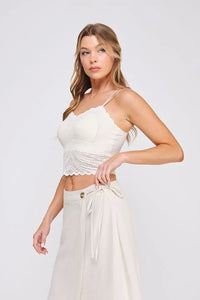 White lace crop top bralette with fine lace pattern scallop edges and beaded embellishment across the midsection