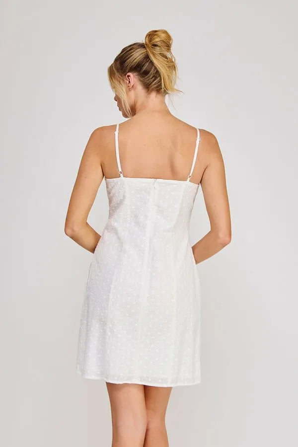White lace strap sweetheart mini dress with thin spaghetti straps and fitted bodice flaring gently at the hem