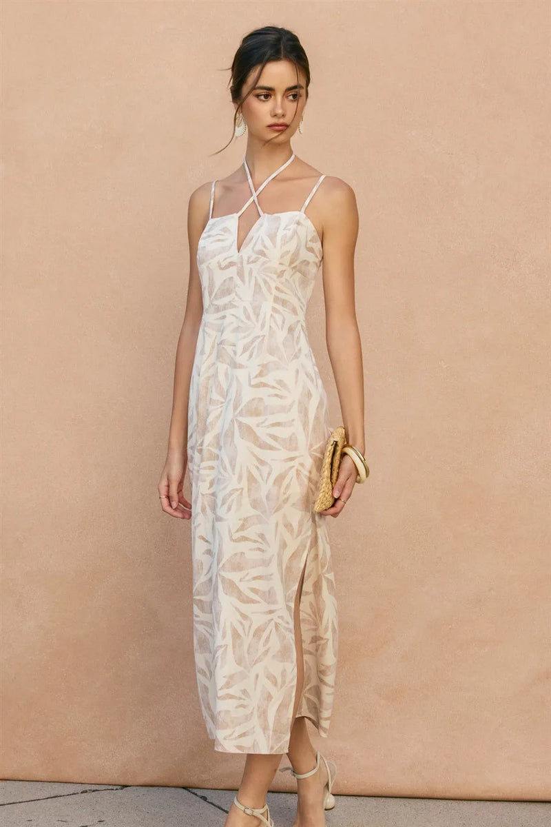 White lace midi dress with tropical leaf pattern and thin spaghetti straps featuring a leaf v cut design