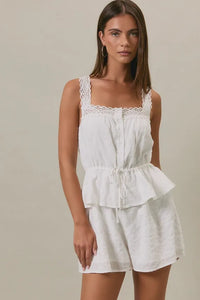 White lace-trimmed peplum romper with square neck lace trim and drawstring waist in relaxed fit design