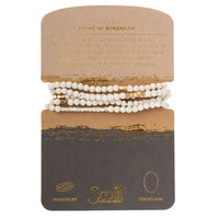 Natural gemstone stone wrap bracelet in white lava stone with gold accents on a branded card for healing use