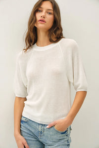 White lightweight ribbed knit raglan top with three quarter sleeves and subtle textured pattern