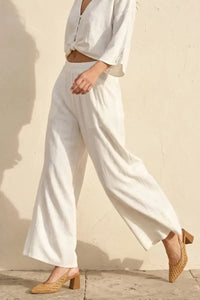 White linen blend wide leg pants with soft hand feel and relaxed flowing silhouette for comfortable wear