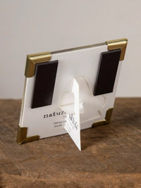 White magnetic picture frame corner magnet with gold-toned corners and black magnets for wise girl women’s boho chic clothing