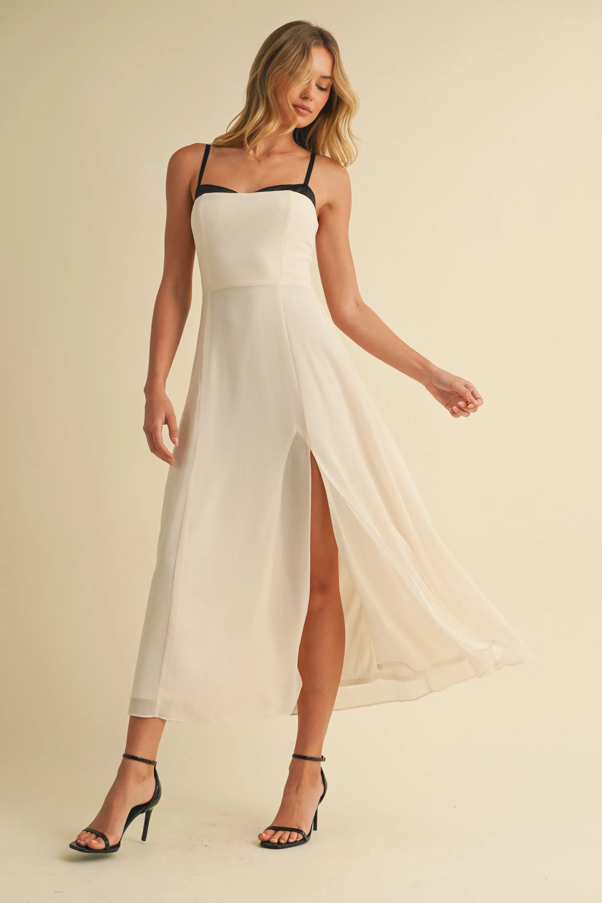 White sweetheart neckline contrast straps midi dress with black spaghetti straps and high slit in lightweight fabric