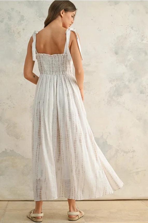 Flowing white women’s maxi dress with tie-back straps and smocked bodice