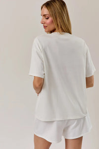 White oversized round neck t shirt with usa flag graphic soft fabric and relaxed fit for casual wear