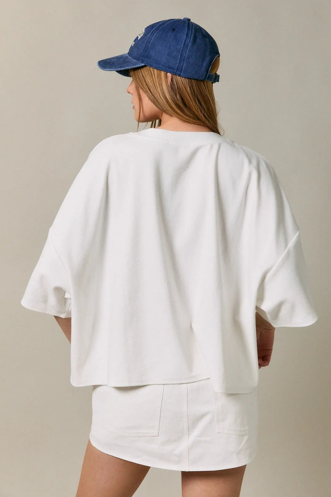 White oversized short sleeve americana top with relaxed fit and soft fabric for casual wear