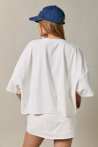 White oversized short sleeve americana top with relaxed fit and soft fabric for casual wear