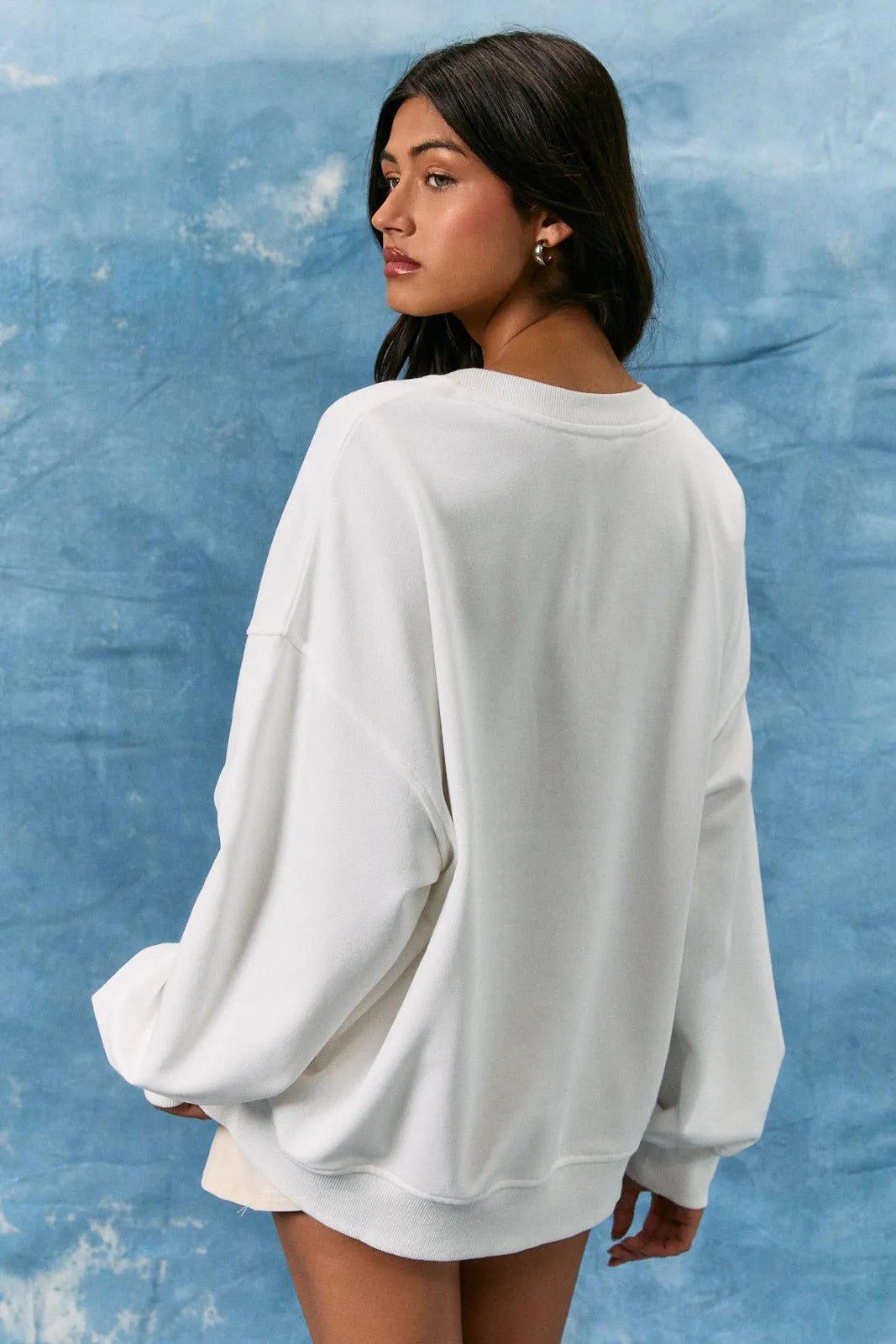 White oversized crew neck sweater with usa flag design and long sleeve crew fit for casual wear