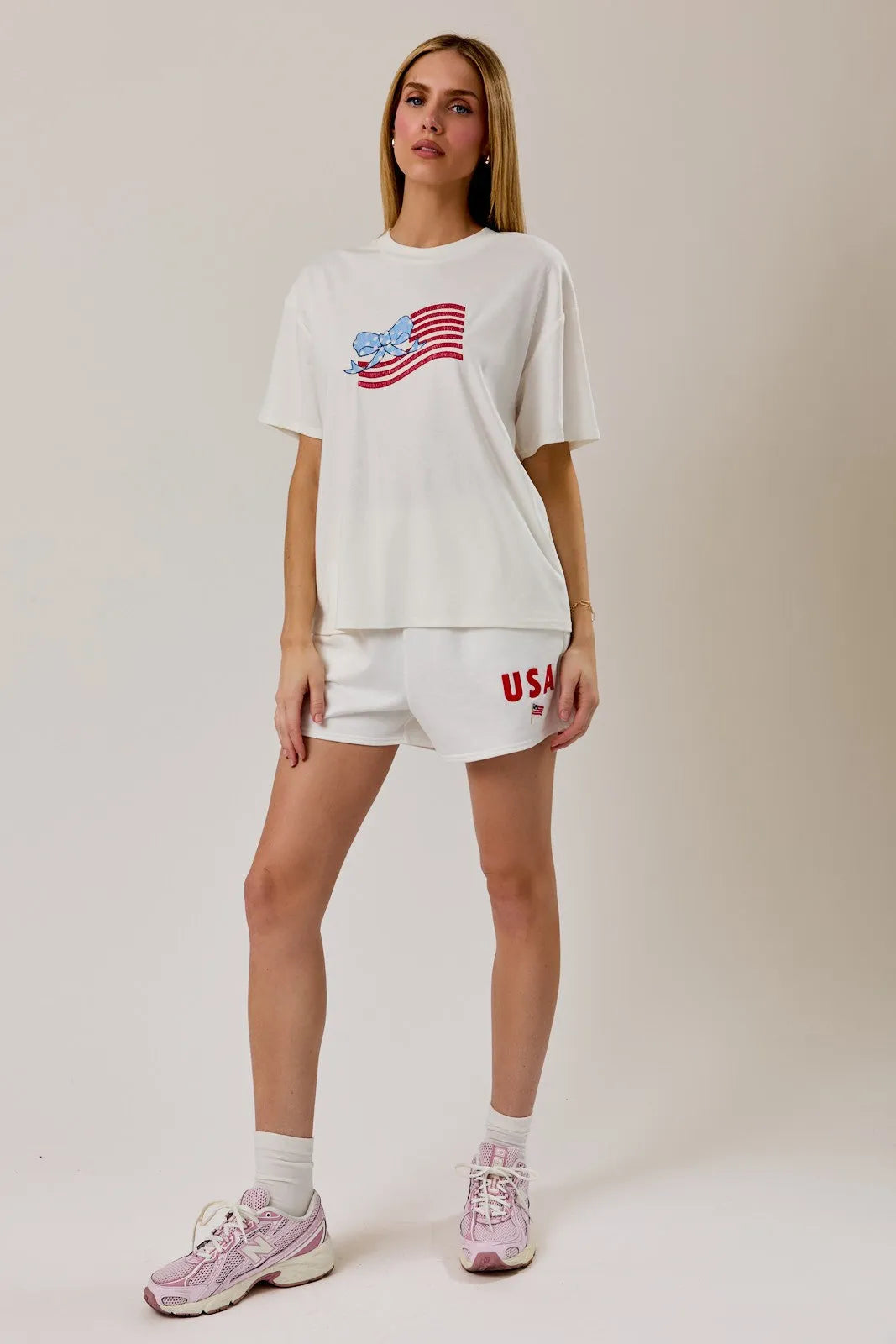 White oversized round neck t shirt with usa flag graphic in red and blue on the chest for casual wear